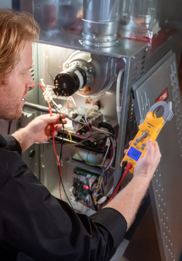 Hollister service technician repairing hvac system.
